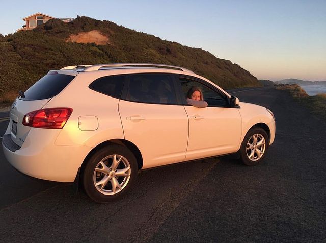 Gracie Dzienny watching out from her luxurious white car's front window.